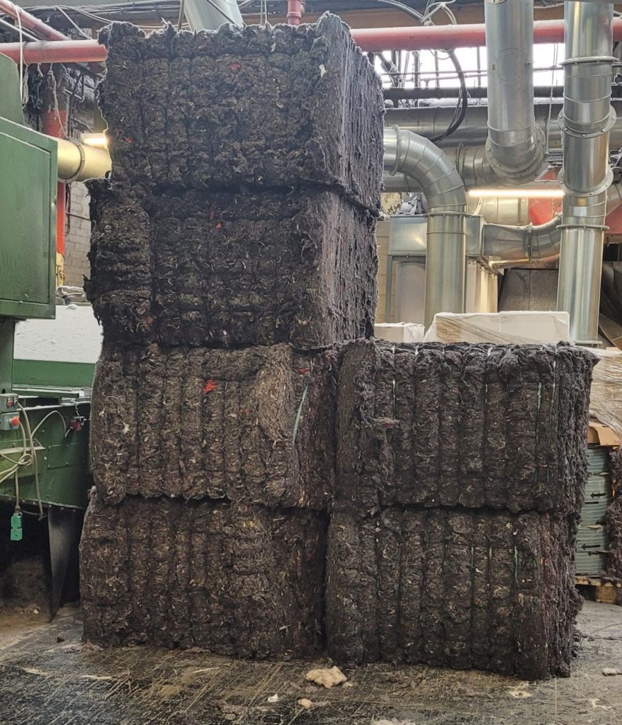 Textile fibre baled using a KME twin ram baler fully automatic